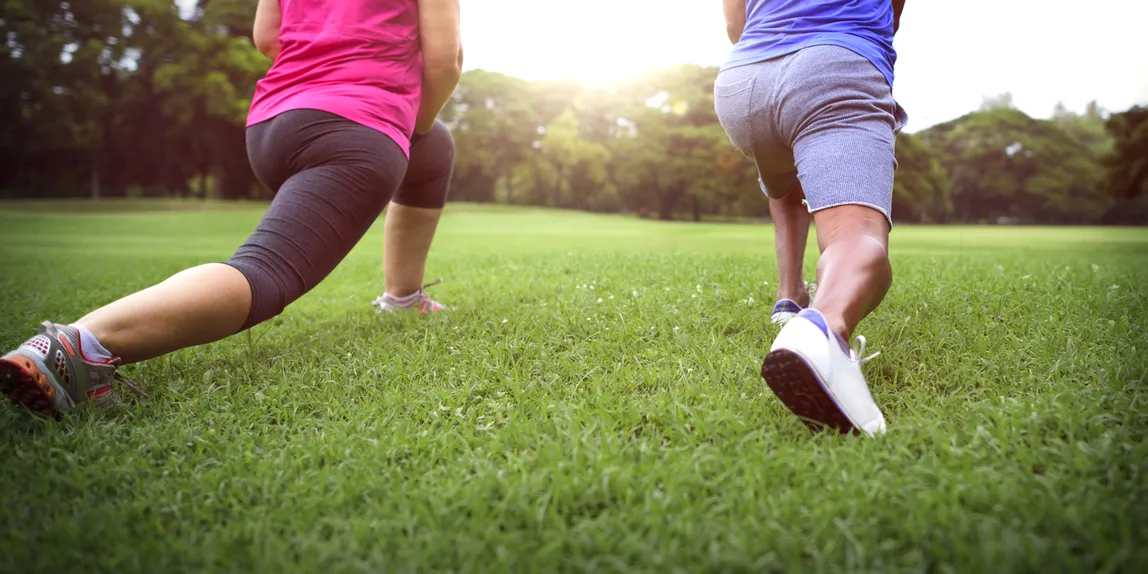 Two people jogging together outdoors on an active morning